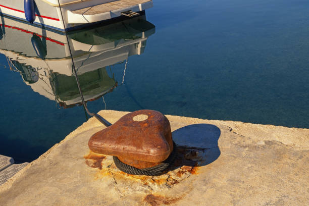 Old mooring bollard with rope on wharf. Montenegro