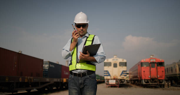 istock The male dock worker working for quality control shipping process in container warehouse for business logistics train station shipping yard, import-export shipping or freight transportation. 2202852858