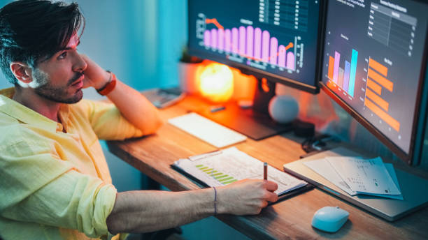 istock Businessman at home working late 2202853861