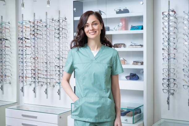 istock Pretty young optic shop assistant smiling nicely and looking contented 2202854177