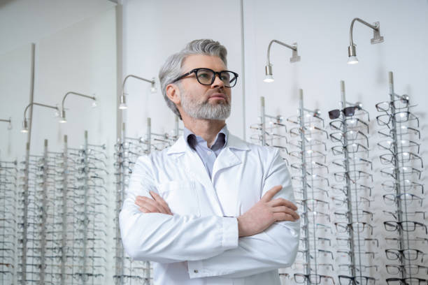 istock Mature caucasian man in lab coat and glasses looking determined 2202854183