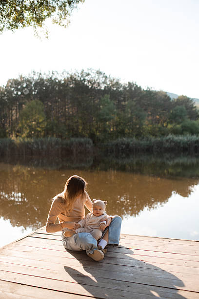 istock Mother holding baby over nature 2202858574