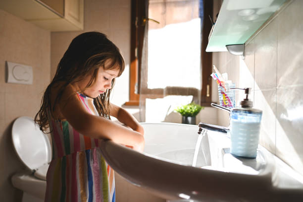 istock Child playing with soap in bathroom. 2202859938