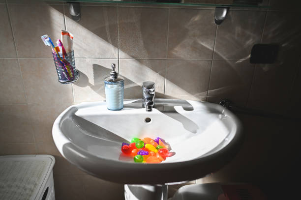 washing toys in a bathroom sink