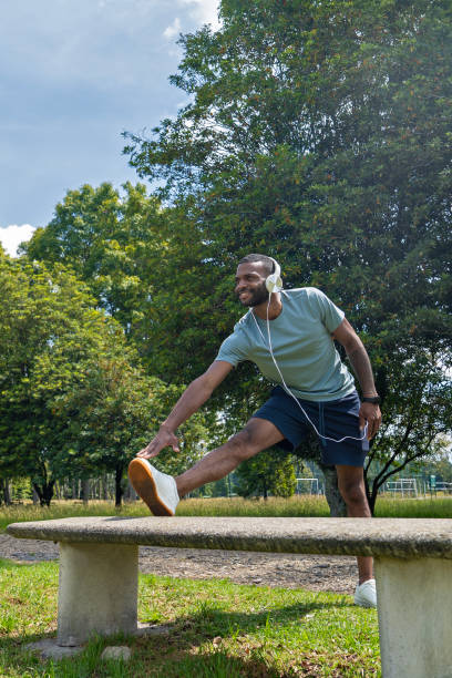 istock A man performs stretching exercises in an outdoor park. 2202860932