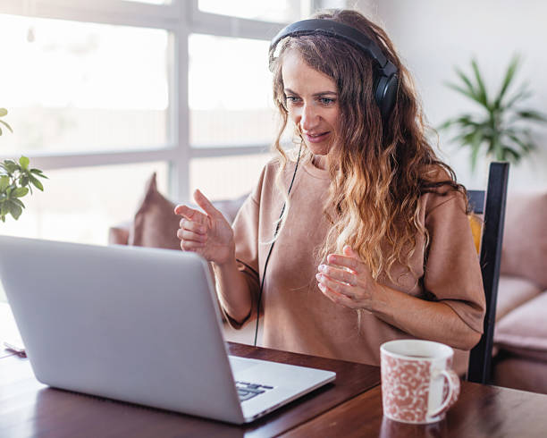 istock Woman in headphones communicates by video call 2202862777