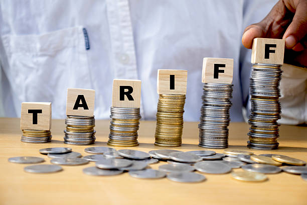 istock Tariff word on wooden cube on pile of coins 2202863449