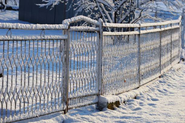 istock fence in the snow in winter 2202863542