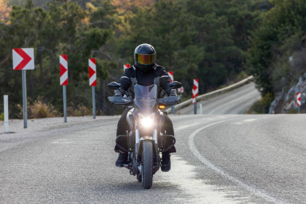 istock An man riding a motorcycle on a long road 2202865263