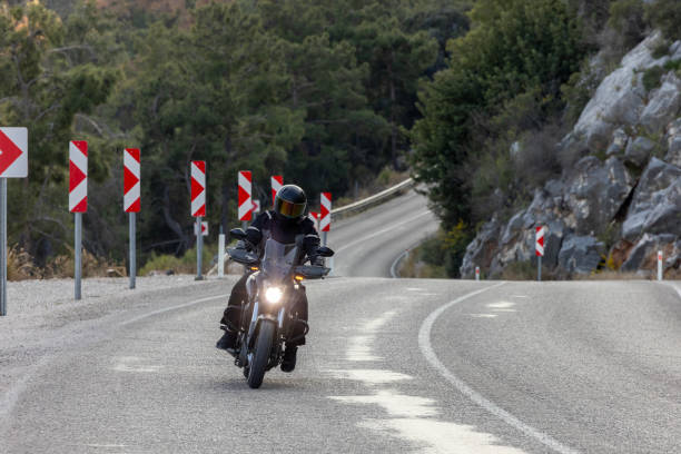 istock An man riding a motorcycle on a long road 2202865433