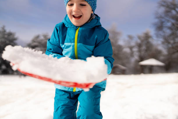Little boy playing in the snow.