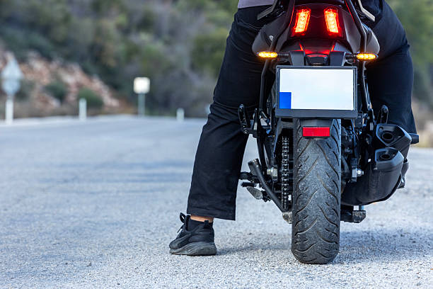 istock An man riding a motorcycle on a long road 2202865450