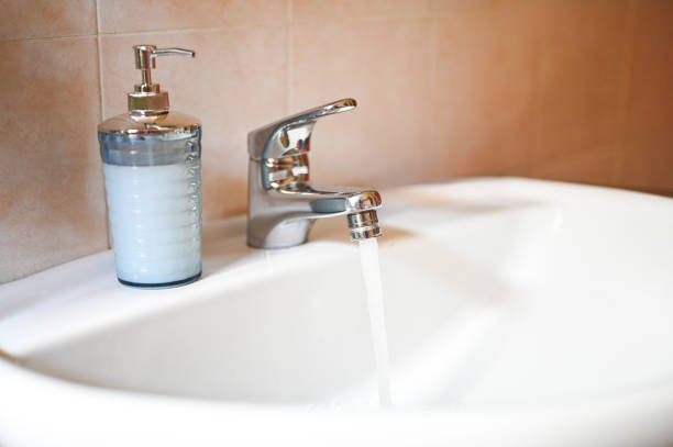 Close up of running water in bathroom.