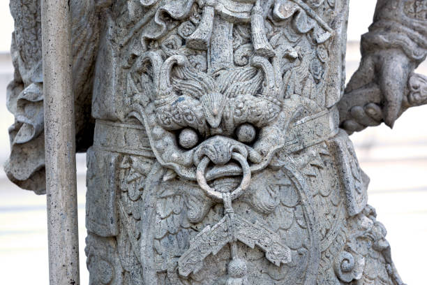 Shot in color detail on the facade of this historic building representing some character, animal or flower. Set at Bangkok, Thailand, Asia