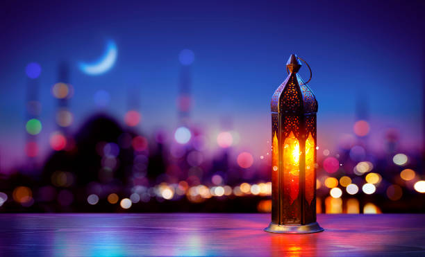 istock Ramadan Kareem - Arabic Lantern With Crescent Moon In City Night - Abstract Magic Bokeh Lights On Background 2202867925
