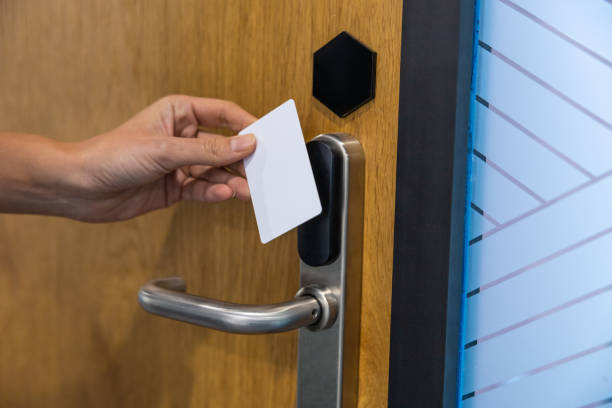 istock Unrecognizable female worker holding digital access card scanning it on electronic reader at hospital 2202869118