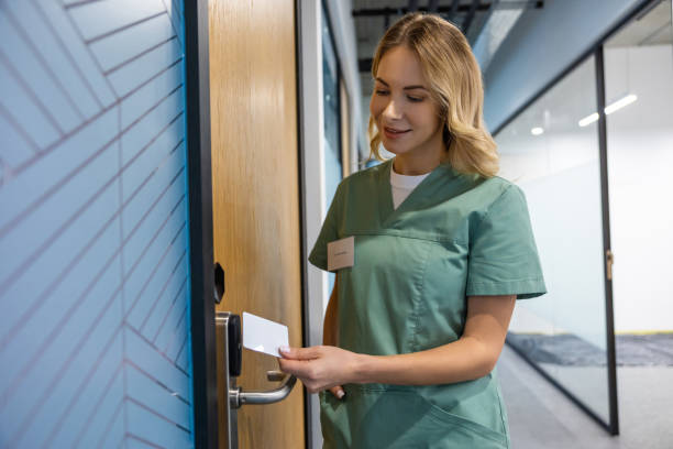 istock Blonde female hospital worker using electronic security system to unlock door 2202869121