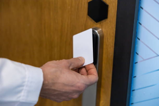 istock Unrecognizable man using scanner at hospital doorway to open lab door 2202869125