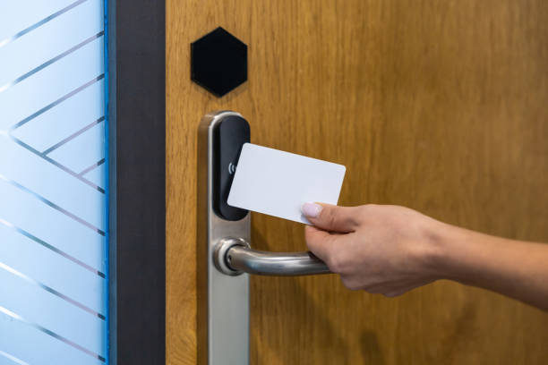 istock Unrecognizable female worker holding digital access card scanning it on electronic reader at hospital 2202869134