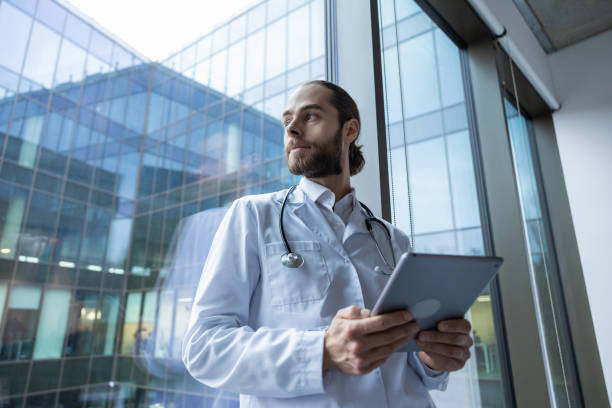 istock Male doctor using tablet for patient care working with digital system in modern hospital 2202869320