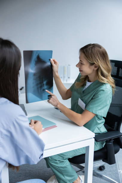 istock Doctor with patient looking at X-ray in office 2202869334