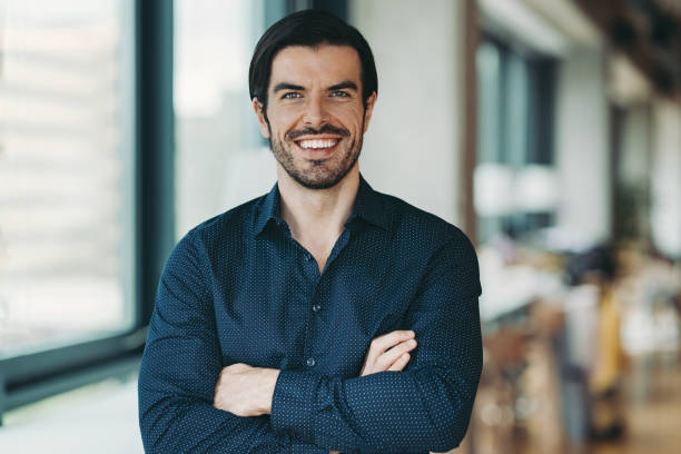 istock Confident businessman standing with crossed arms 2202869387