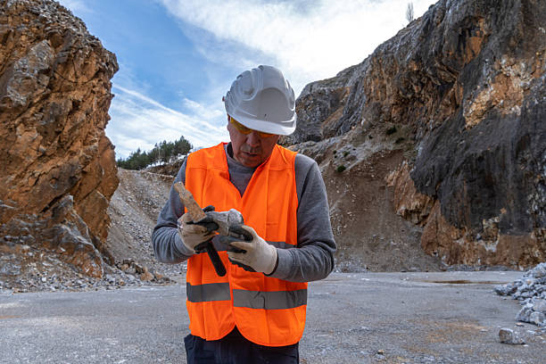 istock Engineer working in stone quarry, performing analysis. Industry and Business. . 2202869856
