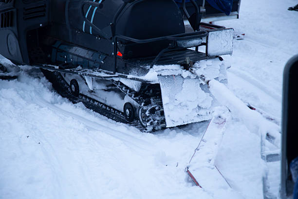 Snowmobile. Snowmobile in the forest on a winter highway. Snowmobile operation.