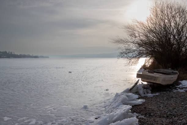 Idyllic scenic view of waves splashing in seascape with snow at beach against cloudy sky during sunset in winter at Syddanmark, Denmark