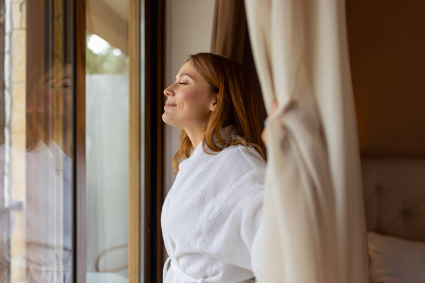 istock Moment of Zen: A Woman’s Relaxed Gaze Out the Window 2202877403