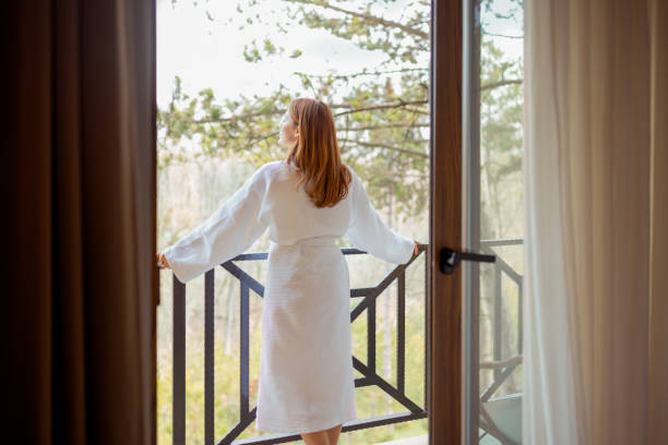 istock Tranquil Escape: A Woman Embracing Nature on a Hotel Balcony 2202877429