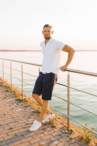 istock Stylish Man Relaxing Near Scenic Waterfront 2202877703