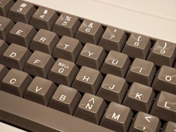 istock Old grey computer keyboard with bell key closeup, vintage style keys, retro mechanical input device, classic computing hardware, nostalgic technology, keyboard keys close-up detail, nobody, 90s 80s 2202878255