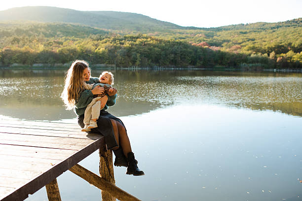 istock Mother with kid daughter over nature background 2202878413