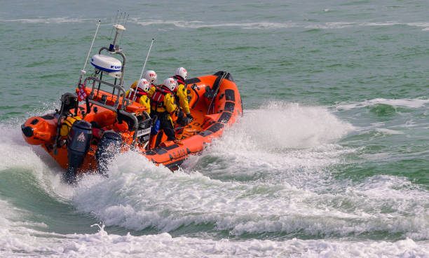 Farne Islands, UK, June 2024: Seahouses lifeboat on a bright sunny summer's day.  The lifeboat is being moved ready for launching in Seahouses harbour on the Northumberland Coast in North East England, UK.