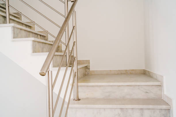 istock Elegant marble staircase with a sleek stainless steel railing. 2202888115