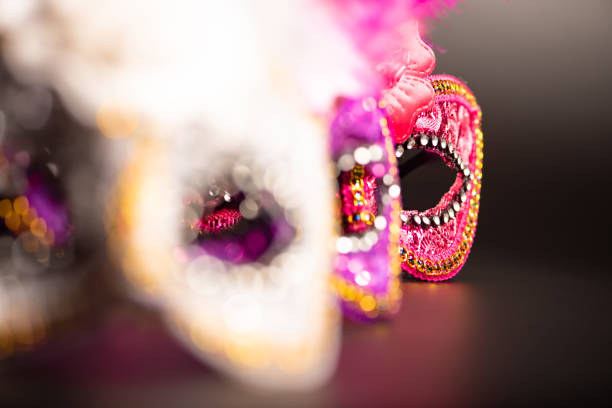 Two pink Mardi Gras masks on green background. Copy space. High resolution 42Mp studio digital capture taken with Sony A7rII and Sony FE 90mm f2.8 macro G OSS lens