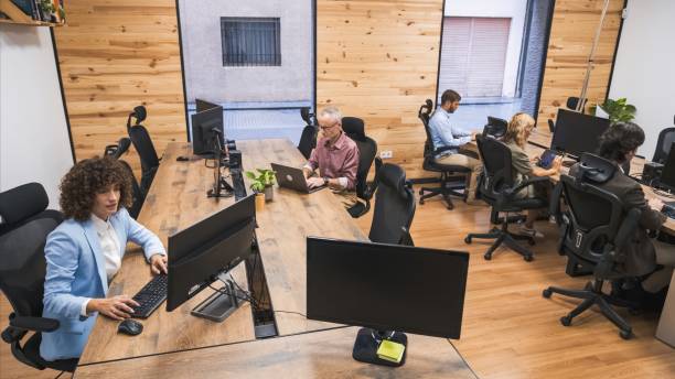 istock From above of business team working on computers in creative office 2202892182