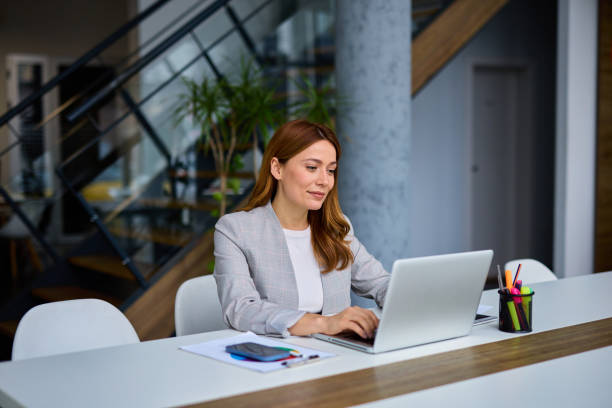 istock Businesswoman working on laptop in modern office 2202893376