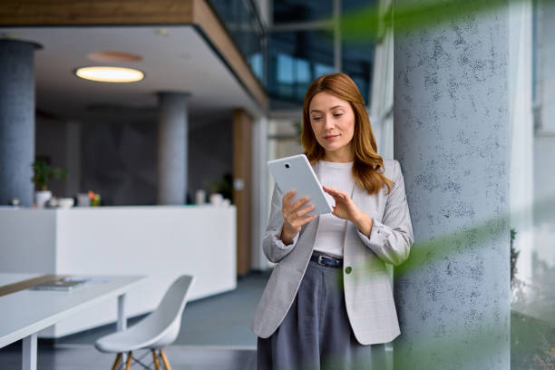 Businesswoman using digital tablet in modern office