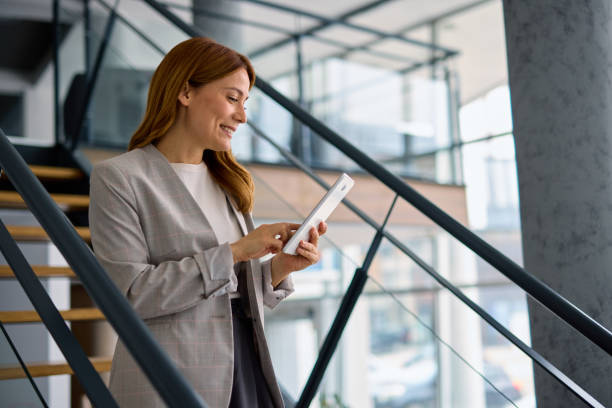 istock Businesswoman using digital tablet in modern office building 2202893579