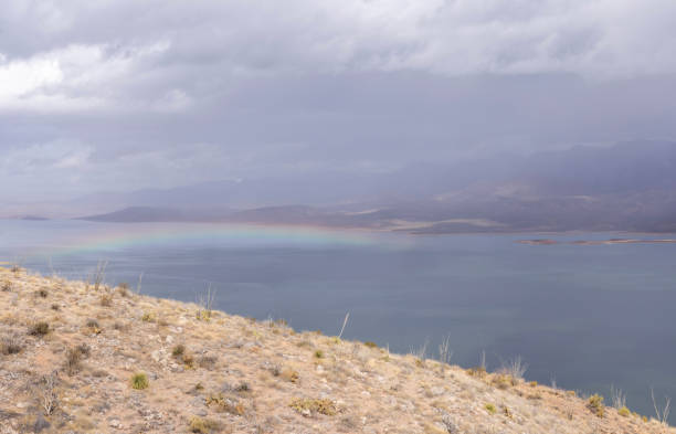 Elevated view of storm and rainbow over lake and desert landscape, Lake Roosevelt, Tonto Basin, AZ