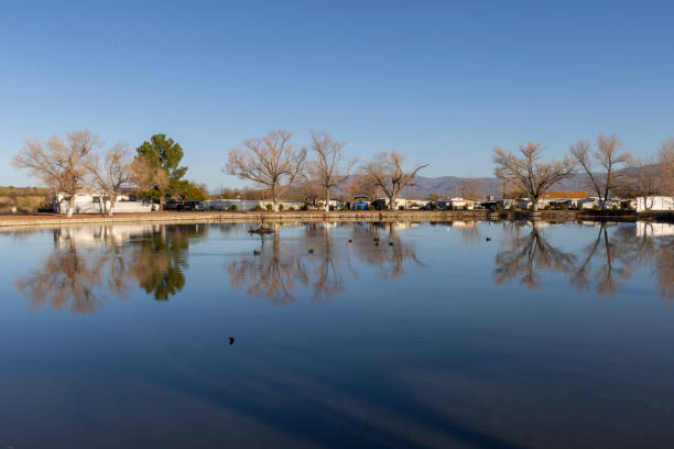View across calm lake and distant trailer park, Tonto Basin, AZ