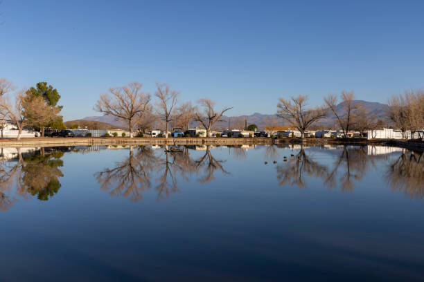 View across calm lake and distant trailer park, Tonto Basin, AZ