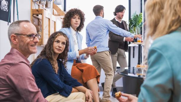 istock Business colleagues having conversation during break in office canteen 2202896957