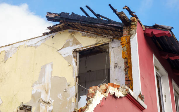istock Partially collapsed house with a damaged roof and crumbling facade 2202897368