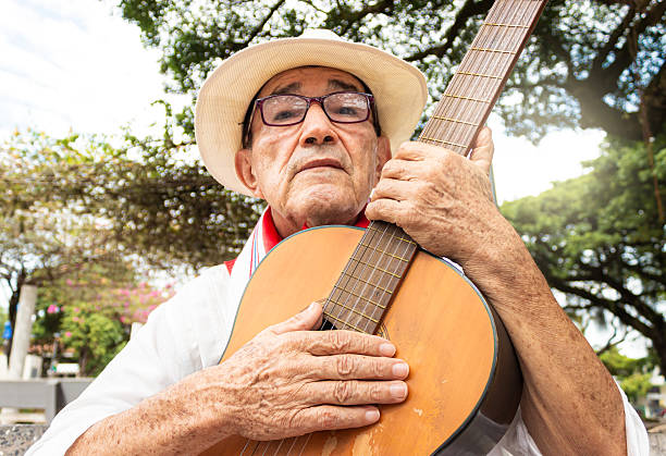 istock A latino man holding a guitar 2202897761