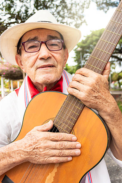 istock A latino man holding a guitar 2202897764