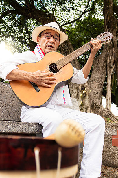 istock An old man singing with an acoustic guitar 2202897827