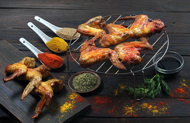 istock grilled chicken wings and spices on a wooden table 2202898901